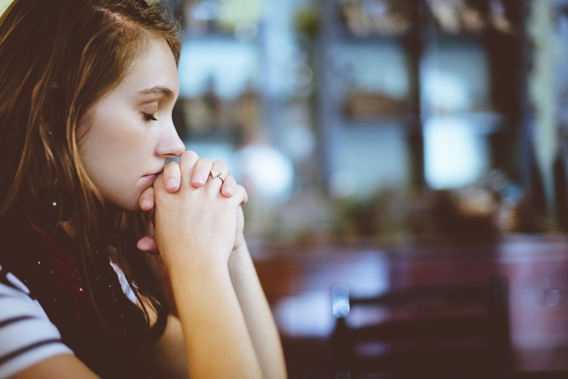 Young Woman With Her Hands Praying